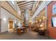 Grand open lobby featuring high ceilings, exposed beams, a stone fireplace, and comfortable seating areas at 13890 E Marina Dr # 107, Aurora, CO 80014