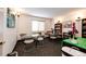 Cozy common room with a window for natural light, tables, chairs, and built-in bookcases at 13890 E Marina Dr # 107, Aurora, CO 80014