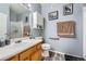 Functional bathroom with classic wooden vanity, framed mirror, and standard fixtures at 3262 E 103Rd Dr # 1810, Thornton, CO 80229
