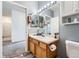 Clean bathroom featuring a vanity with double mirrors and access to additional rooms at 3262 E 103Rd Dr # 1810, Thornton, CO 80229