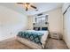 Cozy bedroom with a stylish bed, ceiling fan, and natural light from the window at 3262 E 103Rd Dr # 1810, Thornton, CO 80229