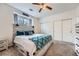 Bright bedroom featuring a decorative bed, ceiling fan, and ample closet space at 3262 E 103Rd Dr # 1810, Thornton, CO 80229