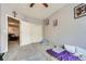 Modest bedroom with neutral walls, minimal decor, and a view into an adjacent living space at 3262 E 103Rd Dr # 1810, Thornton, CO 80229