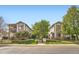 Charming townhomes featuring manicured lawns, mature trees, and inviting entrances at 3262 E 103Rd Dr # 1810, Thornton, CO 80229