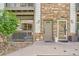 A welcoming front entrance with stone accents, a covered porch, and a well-maintained walkway at 3262 E 103Rd Dr # 1810, Thornton, CO 80229