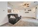 Open-concept living room with comfortable seating, ceiling fan, and view into the kitchen area at 3262 E 103Rd Dr # 1810, Thornton, CO 80229