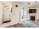 Bright living room featuring a fireplace, sliding glass door, and neutral-toned carpet at 3262 E 103Rd Dr # 1810, Thornton, CO 80229