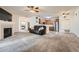 Spacious living area flows to kitchen, with fireplace, modern appliances and gray tone carpet at 3262 E 103Rd Dr # 1810, Thornton, CO 80229