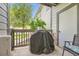Outdoor patio featuring a covered grill and partial view of the surrounding greenery at 3262 E 103Rd Dr # 1810, Thornton, CO 80229