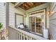 Small outdoor patio area with grill, seating, and partial view of an interior living room at 3262 E 103Rd Dr # 1810, Thornton, CO 80229