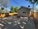 Backyard with concrete patio, wooden fence, and mature trees, creating a private outdoor space at 3440 W 33Rd Ave, Denver, CO 80211