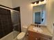 Bathroom with a glass-enclosed shower, granite countertop, and ample lighting with traditional accents at 3440 W 33Rd Ave, Denver, CO 80211