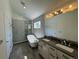 Well-lit bathroom featuring a freestanding tub, double sink vanity, and a glass-enclosed shower at 3440 W 33Rd Ave, Denver, CO 80211