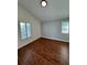 Bedroom with hardwood floors, large windows with shutters, and soft blue walls, creating a serene space at 3440 W 33Rd Ave, Denver, CO 80211