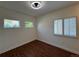 Cozy bedroom with hardwood floors, neutral paint, and bright windows with shutters at 3440 W 33Rd Ave, Denver, CO 80211