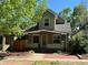 Charming home with a brick pathway leading to a cozy front porch, surrounded by mature trees at 3440 W 33Rd Ave, Denver, CO 80211