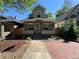 Inviting home with a covered porch, a brick walkway, and lush landscaping enhancing curb appeal at 3440 W 33Rd Ave, Denver, CO 80211