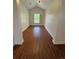 Cozy hallway with wood floors leading to a bright window with white shutters offering natural light at 3440 W 33Rd Ave, Denver, CO 80211
