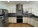 Modern kitchen featuring stainless steel appliances, gray subway tile backsplash, and custom cabinetry at 3440 W 33Rd Ave, Denver, CO 80211