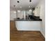 Modern kitchen with a breakfast bar, stainless steel appliances, and elegant pendant lighting at 3440 W 33Rd Ave, Denver, CO 80211