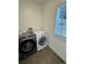 Convenient laundry room featuring modern washer and dryer units and tile floors at 3440 W 33Rd Ave, Denver, CO 80211