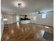 Spacious living room with hardwood floors, modern lighting, and an open concept design flowing into the kitchen at 3440 W 33Rd Ave, Denver, CO 80211