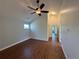 Bright living room featuring wood floors, a ceiling fan, and an open view of the home's layout at 3440 W 33Rd Ave, Denver, CO 80211