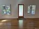 Living room featuring hardwood floors, windows with shutters, and a glass door, providing a bright view at 3440 W 33Rd Ave, Denver, CO 80211