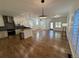 Open concept living room and kitchen with hardwood floors and stainless steel appliances at 3440 W 33Rd Ave, Denver, CO 80211