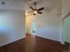 Spacious living room with warm wood floors, a ceiling fan, and access to other rooms in the house at 3440 W 33Rd Ave, Denver, CO 80211