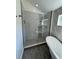 Contemporary glass shower features tile, a rainfall showerhead, and built-in shelving for storage at 3440 W 33Rd Ave, Denver, CO 80211