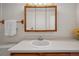 This is a bathroom with a vanity, sink, mirror, and towel bar at 12108 Melody Dr # 103, Denver, CO 80234