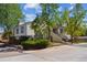 Cottonwood Villas Recreation Center features an inviting entrance, landscaping, and mature trees at 12108 Melody Dr # 103, Denver, CO 80234