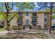 Two-story apartment building featuring four balconies, neutral paint, and a well-kept lawn at 12108 Melody Dr # 103, Denver, CO 80234