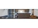 Galley kitchen with bar countertop, stainless steel appliances, and dark countertops at 12108 Melody Dr # 103, Denver, CO 80234