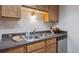 Galley kitchen featuring stainless steel appliances, grey countertop, and stainless steel sink at 12108 Melody Dr # 103, Denver, CO 80234