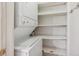 A laundry area featuring a stacked washer and dryer and shelving for storage at 12108 Melody Dr # 103, Denver, CO 80234