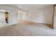 Spacious living room with neutral carpet, white walls, and open floor plan for versatile decorating at 12108 Melody Dr # 103, Denver, CO 80234