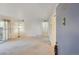 Inviting living room featuring carpet, light-colored walls, and door to outdoor balcony at 12108 Melody Dr # 103, Denver, CO 80234
