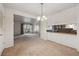 Open concept living room with view to kitchen and dining areas in a bright setting at 12108 Melody Dr # 103, Denver, CO 80234