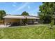 Backyard with a well-maintained lawn and awning-covered patio perfect for entertaining at 5030 Titan Ct, Denver, CO 80239
