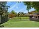 Spacious backyard featuring a shed, artificial turf and secure fencing at 5030 Titan Ct, Denver, CO 80239