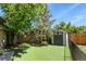 Well-manicured backyard featuring a storage shed and lush artificial turf at 5030 Titan Ct, Denver, CO 80239