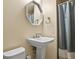 Bathroom showcasing a pedestal sink with an octagonal mirror above at 5030 Titan Ct, Denver, CO 80239