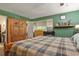 A bright bedroom with a large wooden armoire and open closet space at 5030 Titan Ct, Denver, CO 80239