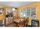Eat-in kitchen with stainless steel appliances, light wood cabinets, and a table with four wooden chairs near a window at 5030 Titan Ct, Denver, CO 80239
