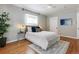 Bright bedroom featuring hardwood floors, a ceiling fan, and neutral decor at 1416 N Downing St # 1, Denver, CO 80218