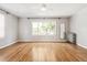 Bright bedroom with hardwood floors, updated windows, and vintage radiator at 1416 N Downing St # 1, Denver, CO 80218