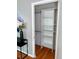 A closet with shelving and hanging rods providing efficient storage at 1416 N Downing St # 1, Denver, CO 80218