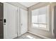 Sunlit entryway includes a storage closet and a window adding brightness to the transitional space at 1416 N Downing St # 1, Denver, CO 80218
